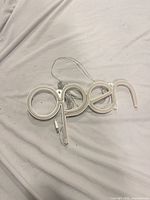 Front view of white LED "open" sign with USB cable attached