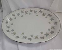 Top view of oval platter showing leaf pattern and silver rim