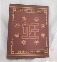 Front cover of reddish-brown Yo-Kai Watch collector binder with gold symbols