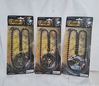 Three sealed pirate medallion necklaces in blister packs