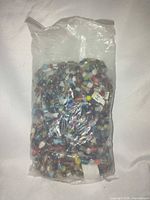 Full view of sealed bag filled with multicoloured glass bead strands