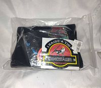 sealed plastic package containing black pouch showing patch logo