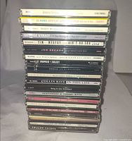 Full stack of 20 CD jewel cases with spines showing titles