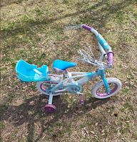 Full view of bicycle from above showing frame, rear doll seat, training wheels