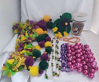 Full lot view: garland, plush toy, cup, assorted bead strands