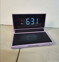 Device open showing 6:31 PM on LED display