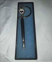 Miniature sword in open display box