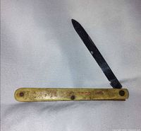 Knife open, left side view showing handle color and branding