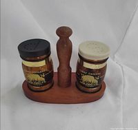Front view of amber glass Luray Caverns salt & pepper shakers in wood stand