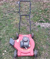 Top view showing red deck, Briggs & Stratton 3.75 HP engine, side discharge chute, handle assembly