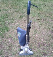 Front view of Royal upright vacuum with blue bag and chrome base