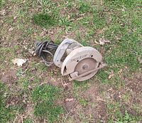 Side view of Skilsaw circular saw on grass