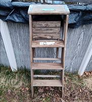Full front view of folded wooden Babcock step ladder