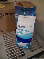 Front view showing both sealed bags: blue 8 lb bag and white-blue 4 lb Equate bag