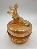 Closed trinket box displaying dog finial and iridescent finish