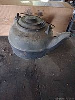 overall view of cast iron kettle with lid and spout
