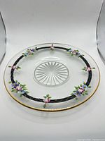 Full view of floral glass plate showing rim, band and centre cuts