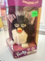 Front view of Furby inside display box
