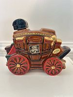 Front view of stagecoach-shaped Ezra Brooks decanter showing label and detailing