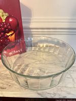 Top view of clear fluted glass serving bowl on marble surface