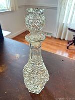 Full view of pressed glass decanter with stopper