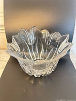 Front angled view of clear cut crystal bowl showing faceted sides and petal rim