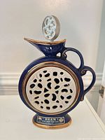 Front view showing white lattice panel, navy body, stopper inserted