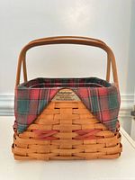 Front view of Longaberger Deck the Halls basket with handle and plaid liner