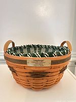 Front view of basket with liner and handles visible