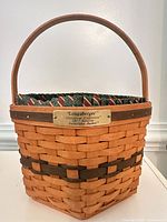 Front view showing basket, handle, liner, brass plate