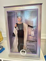 Front view of boxed Audrey Hepburn doll and accessories