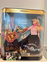 Front view of boxed Barbie Loves Elvis Collector Edition set showing both dolls and accessories