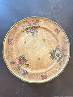 Single plate showing floral pattern, crackle glaze and green rim