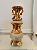 Full view of gold and pearlescent Jim Beam decanter