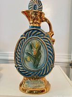 Full view of blue and gold Jim Beam tulip decanter