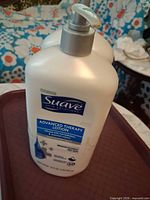 Front angled view showing two Suave Advanced Therapy Lotion bottles
