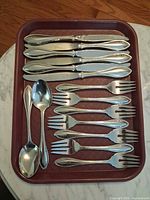 Top view of all 15 flatware pieces on tray
