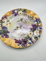 Front view of Crown Jewels plate showing hummingbird and floral artwork