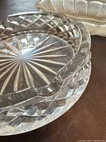 Round faceted glass ashtray showing starburst bottom