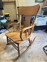 Full view of wooden rocking chair showing design and overall condition