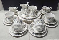 Full set arranged, showing cups, saucers, plates, creamer, sugar bowl, bud vases