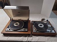 Both Connoisseur BD2/A turntables side by side showing wood plinths, one with dust cover