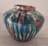 Side view showing vase shape and multicolour flambe drip glaze