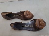 Top view showing both sandals, CHANEL gold insole branding visible