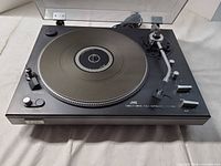 Top view of JVC JL-F45 turntable showing platter, tonearm, controls and dust cover