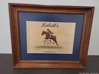 Framed Labatt's equestrian print with blue mat and wood frame