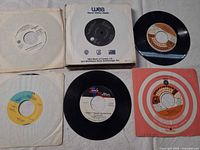 Six of the records displayed, company sleeves and labels visible