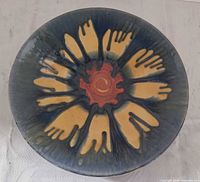 Top view showing abstract floral glaze pattern and overall condition