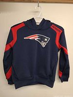 Front view of navy/red New England Patriots youth hoodie