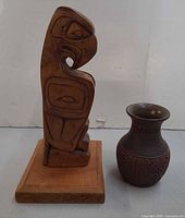 Wood bird carving and ceramic vase front view